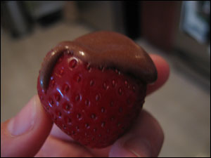 Vegan Chocolate Frosting on a Strawberry